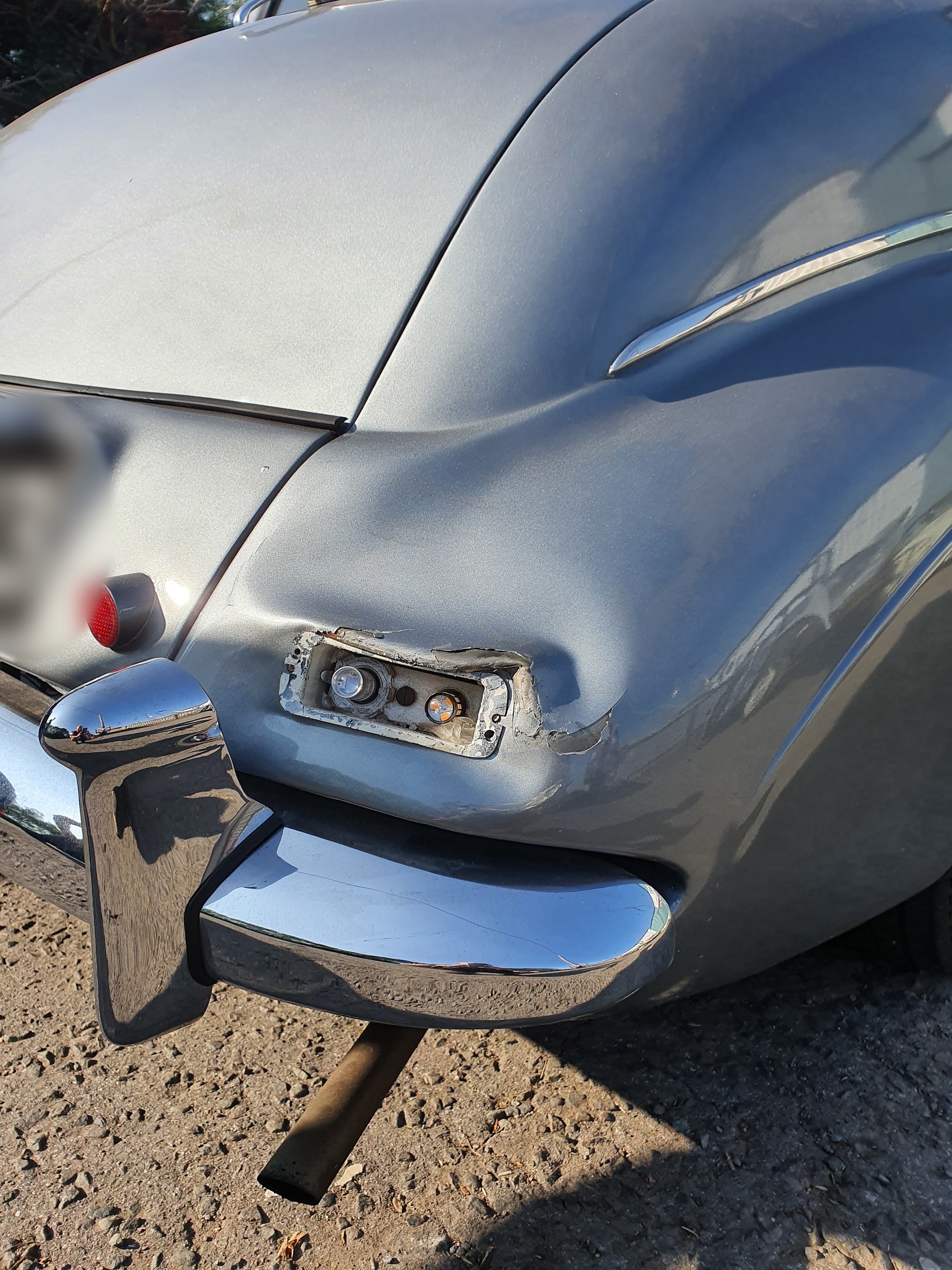 Before: the classic car’s grey rear wing, dented and torn around the rear lamp housing
