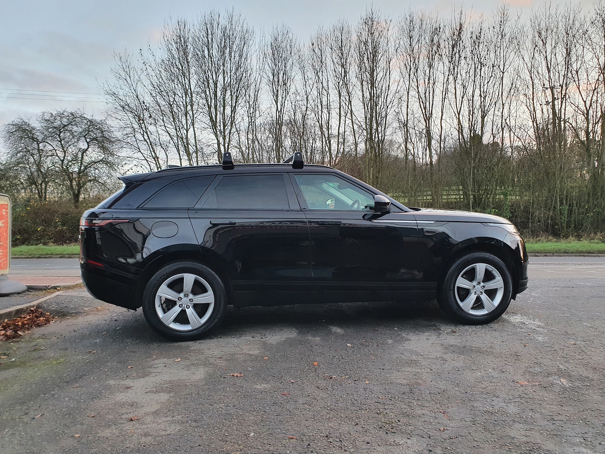 A black Range Rover Velar in profile on the yard